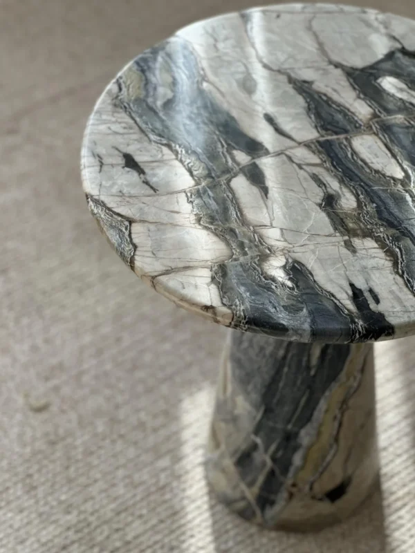 Dusk Light Marble Round Side Table on Cone Base in black — in a room setting
