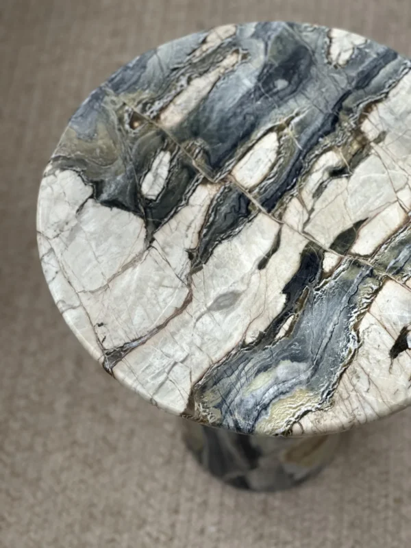 Dusk Light Marble Round Side Table on Cone Base in black — in a room setting