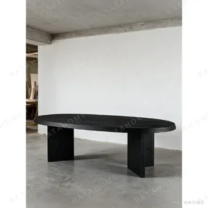 Ellipse Black Oak Dining Table on Twin Panel Legs in black — in a room setting