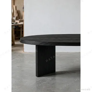 Ellipse Black Oak Dining Table on Twin Panel Legs in black — in a room setting