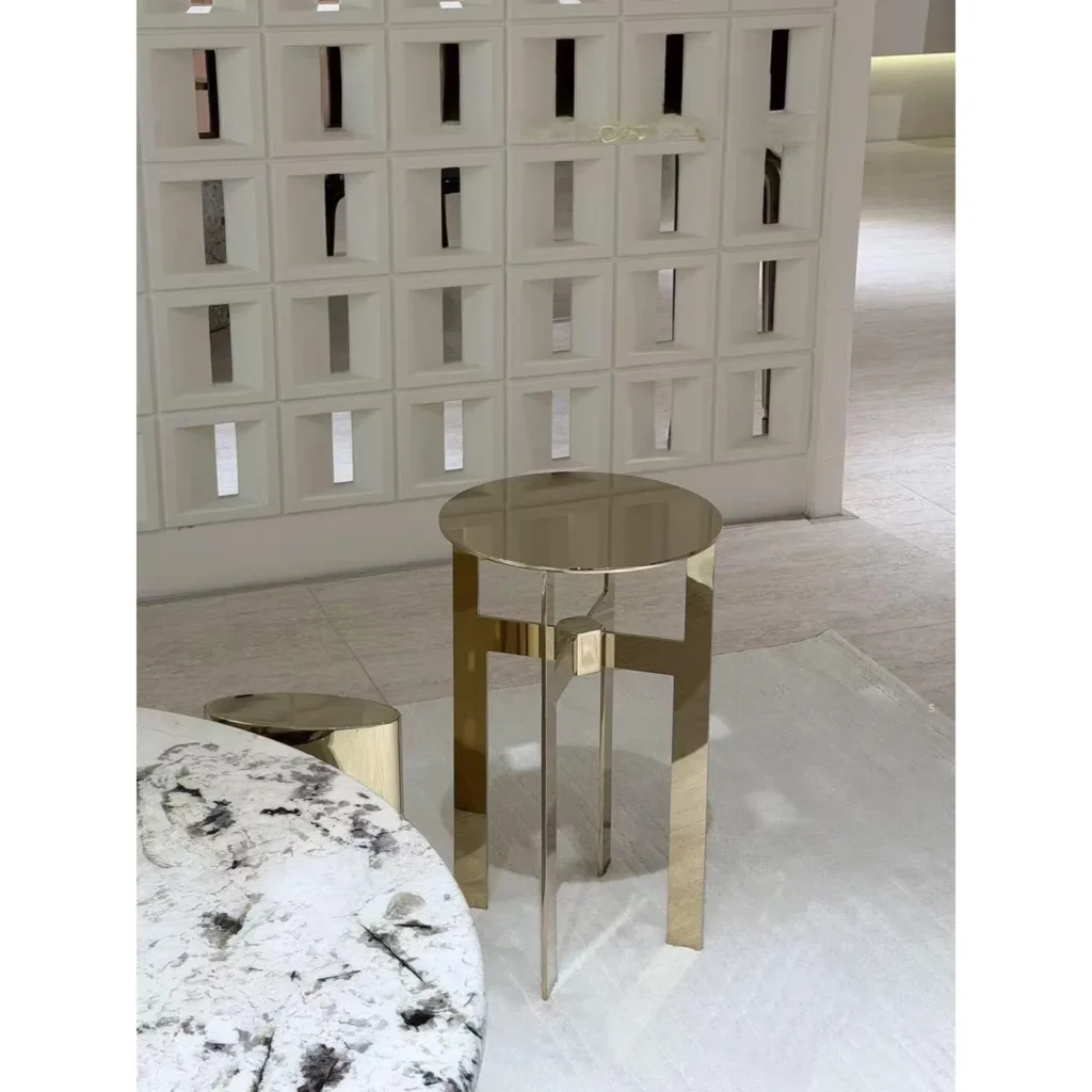 Polished Brass Cross-Frame Round Side Table in brushed brass — in a room setting