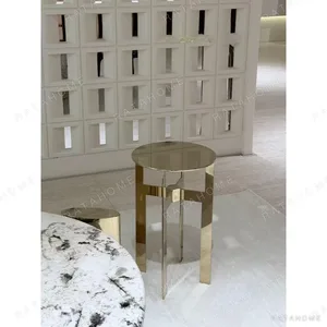 Polished Brass Cross-Frame Round Side Table in brushed brass — in a room setting