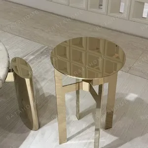 Polished Brass Cross-Frame Round Side Table in brushed brass — in a room setting