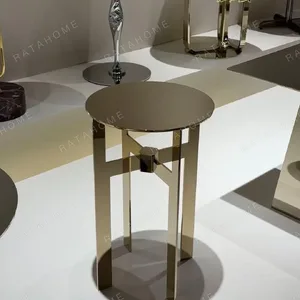 Polished Brass Cross-Frame Round Side Table in brushed brass — in a room setting