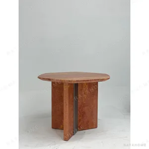 Red Travertine Round Dining Table in rust — in a room setting