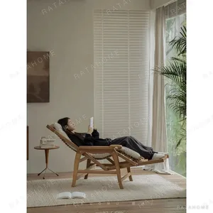 Teak and Rattan Extendable Recliner with Corduroy Cushion in clay — in a room setting