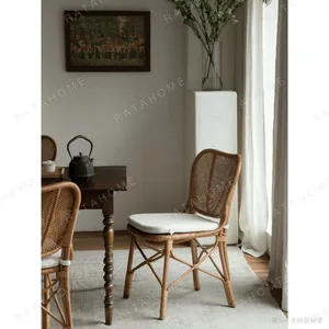 Fan-Back Rattan Chair with Seat Cushion in clay — in a room setting