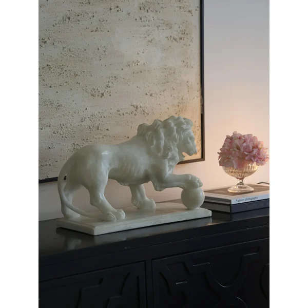 Jade-Effect Guardian Lion with Ball Sculpture in ivory — in a room setting