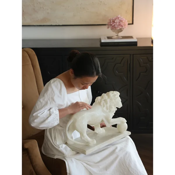 Jade-Effect Guardian Lion with Ball Sculpture in ivory — in a room setting