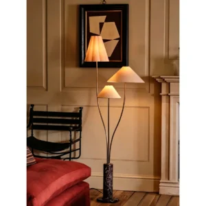 Felden Three-Shade Floor Lamp on Rosso Marble Base in oatmeal — in a room setting