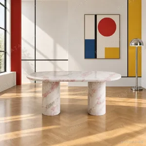 Soft Pink Marble Oval Dining Table on Column Legs in rose stone — in a room setting