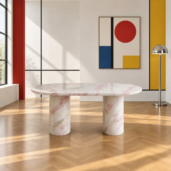 Soft Pink Marble Oval Dining Table on Column Legs in rose stone — in a room setting