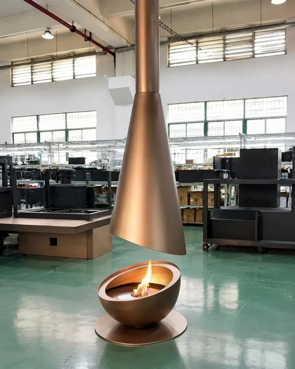 Outdoor Suspended Cone Fireplace in brushed brass — in a room setting