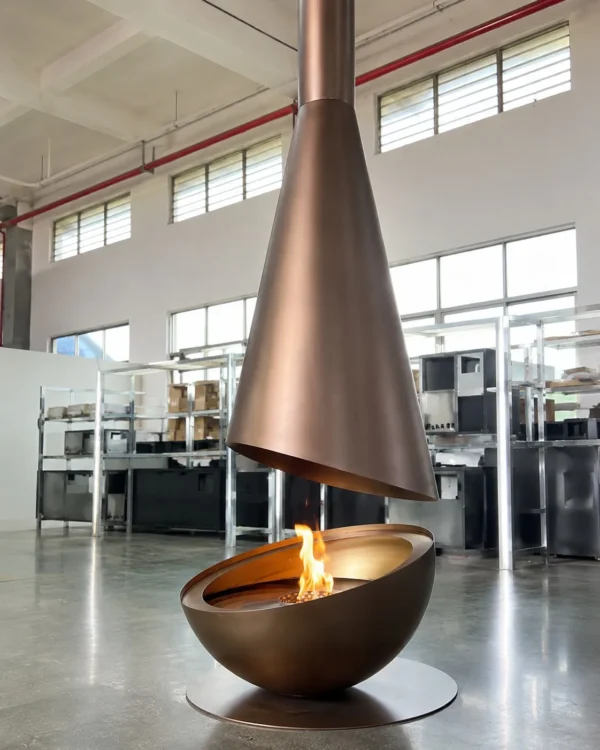 Outdoor Suspended Cone Fireplace in brushed brass — in a room setting
