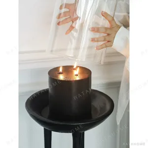 Black Wood Tripod Floor Candle Holder with Tray Top in black — in a room setting