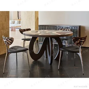 Flowing Marquetry Round Table on Sculptural Wave Base in clay — in a room setting