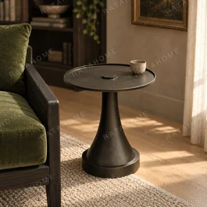 Forged Brass Round Side Table with Textured Top, 40 cm in black — in a room setting