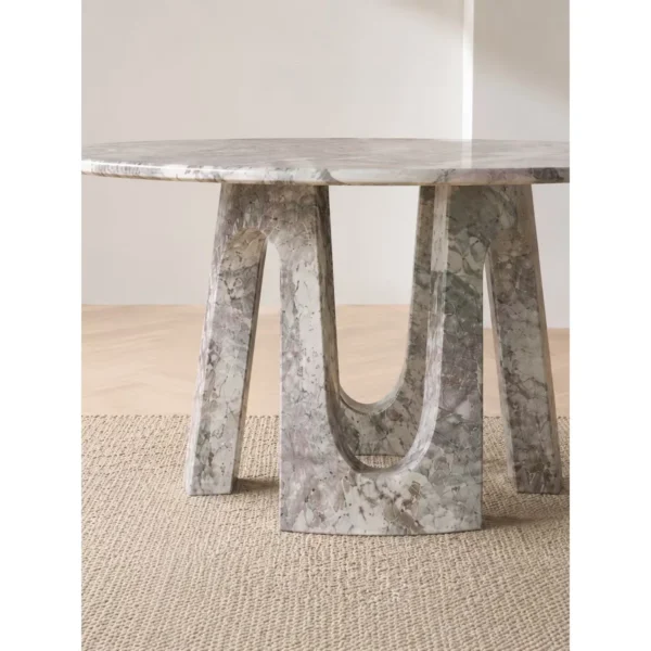 Four Seasons Pink-Green Marble Round Table on Arched Base in rose stone — in a room setting