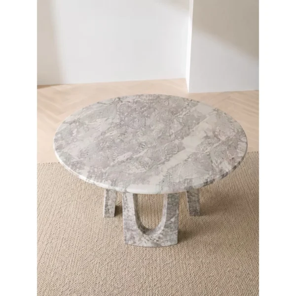 Four Seasons Pink-Green Marble Round Table on Arched Base in rose stone — in a room setting