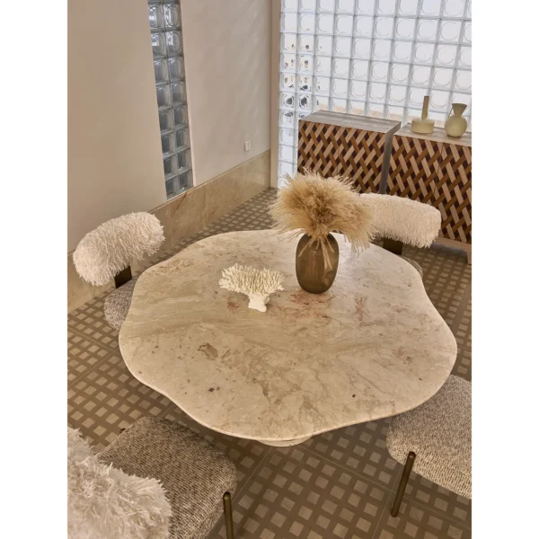 Four Seasons Pink Stone Wave-Edge Dining Table on Brass Base in rose stone — in a room setting