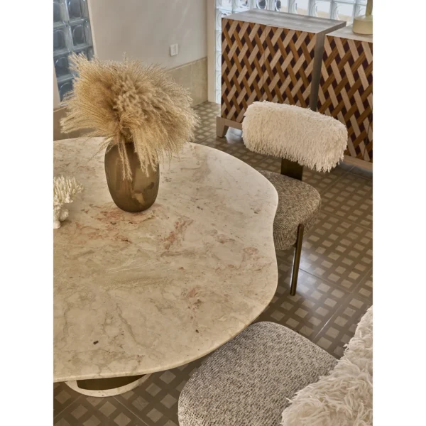 Four Seasons Pink Stone Wave-Edge Dining Table on Brass Base in rose stone — in a room setting
