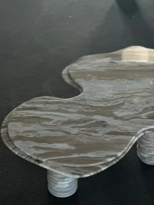 Free-Form Wave Marble Coffee Table on Fluted Legs in slate — in a room setting