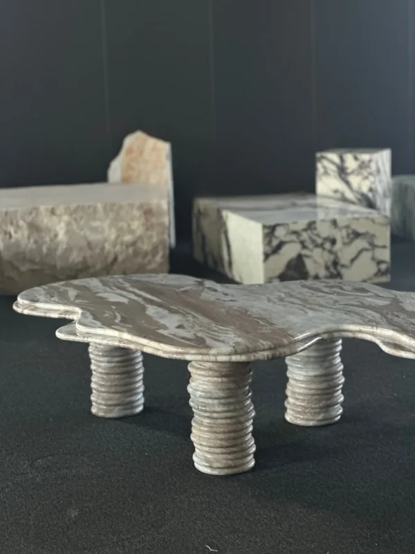Free-Form Wave Marble Coffee Table on Fluted Legs in slate — in a room setting
