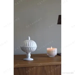 White Ribbed Ceramic Urn Vase with Pedestal Foot in ivory — in a room setting