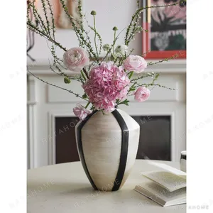 French Mid-Century Cream Vase with Black Geometric Lines in oatmeal — in a room setting