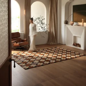 Geometric Patchwork Cowhide Rug in Brown and Cream — in a room setting