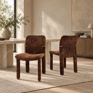 Geometric Pattern Upholstered Dining Chair with Brass Detail in rust — in a room setting