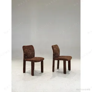 Geometric Pattern Upholstered Dining Chair with Brass Detail in rust — in a room setting
