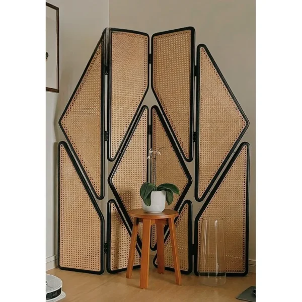 Geometric Cane Panel Folding Screen with Aged Hinges in natural oak — in a room setting