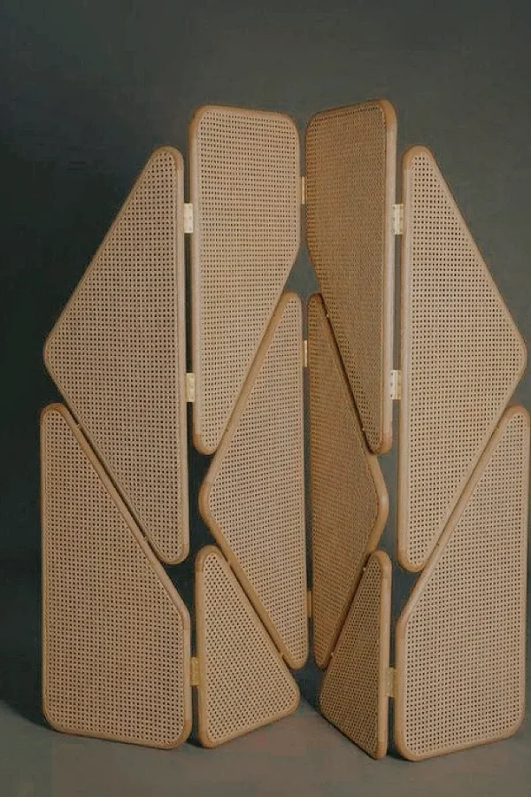 Geometric Cane Panel Folding Screen with Aged Hinges in natural oak — in a room setting