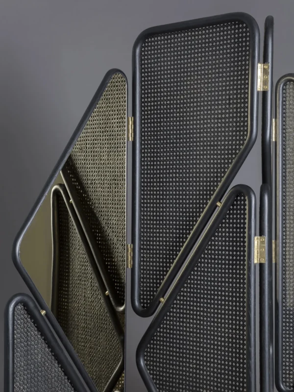 Geometric Cane Panel Folding Screen with Aged Hinges in natural oak — in a room setting