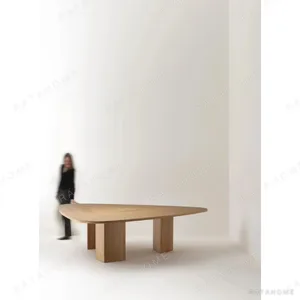 Gliding Oak Veneer Dining Table with Rounded Triangular Top in natural oak — in a room setting