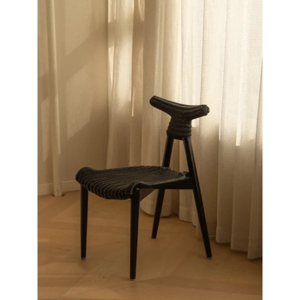 Goat Horn Black Teak Chair with Woven Rattan Seat in black — in a room setting