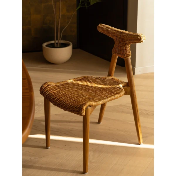 Goat Horn Black Teak Chair with Woven Rattan Seat in black — in a room setting