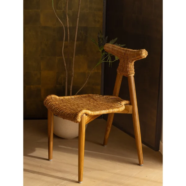 Goat Horn Black Teak Chair with Woven Rattan Seat in black — in a room setting