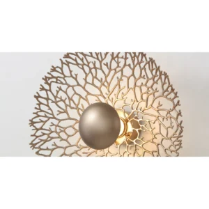 Gold Coral Lace Round Wall Light with Black Centre in brushed brass — in a room setting