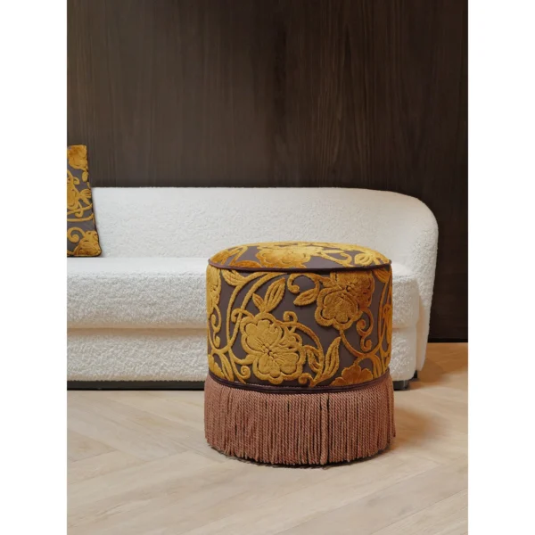 Gold Floral Cut Velvet Pouf with Fringe in brushed brass — in a room setting