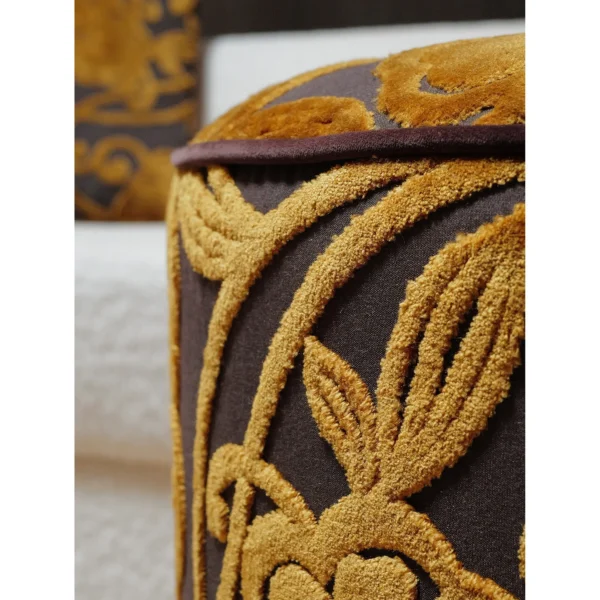 Gold Floral Cut Velvet Pouf with Fringe in brushed brass — in a room setting