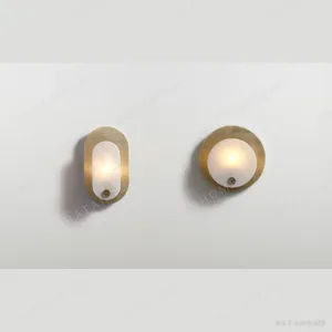 Gold Mesh Oblong Wall Light with Alabaster-Look Panel in brushed brass — in a room setting