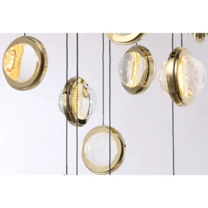 Gold Rim Vertical Glass Disc Pendant Light in brushed brass — in a room setting