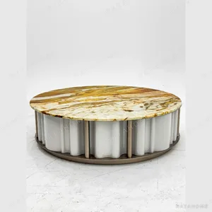 Round Gold Vein Stone Coffee Table on Fluted White Base in brushed brass — in a room setting