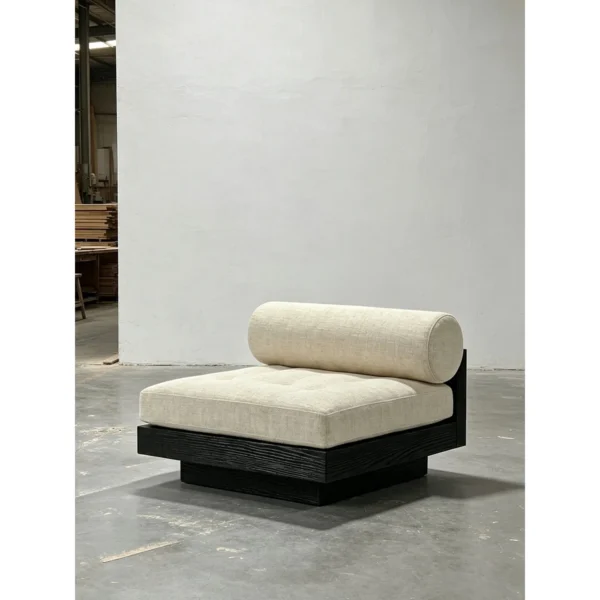 Black Oak Plinth Lounge Chair with Linen Cushion and Bolster in black — in a room setting