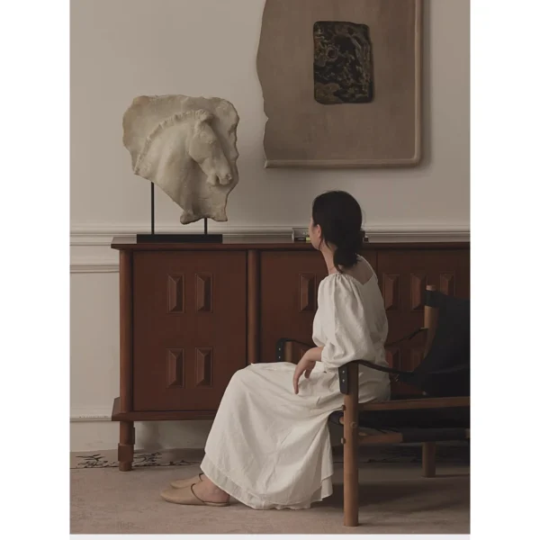 Greek Horse Relief Fragment on Black Metal Stand in ivory — in a room setting