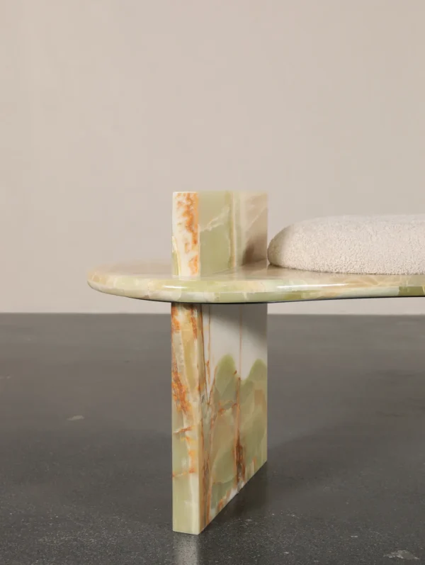 Green Onyx Curved Bench with Bouclé Cushion in olive — in a room setting