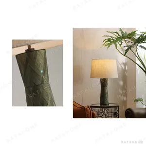 Green Faceted Ceramic Table Lamp with Linen Shade in olive — in a room setting