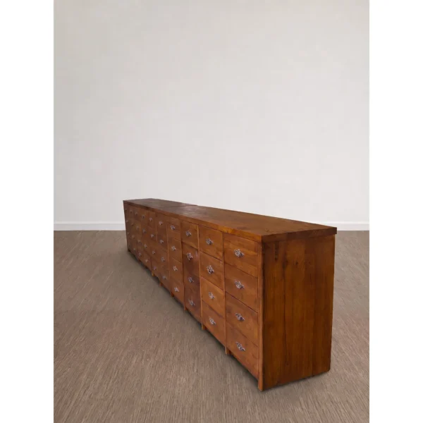 Grid Sequence Long Chest with Rows of Small Drawers in clay — in a room setting